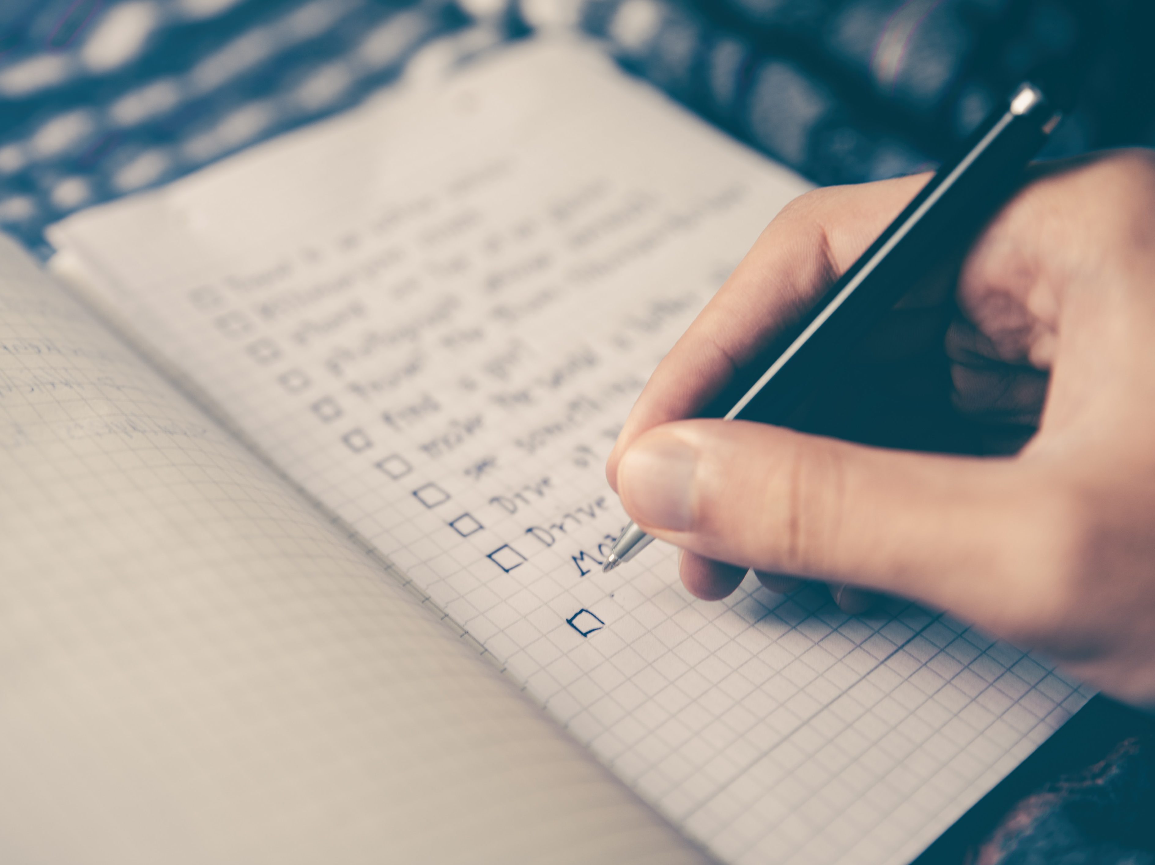 Photo of person writing a list