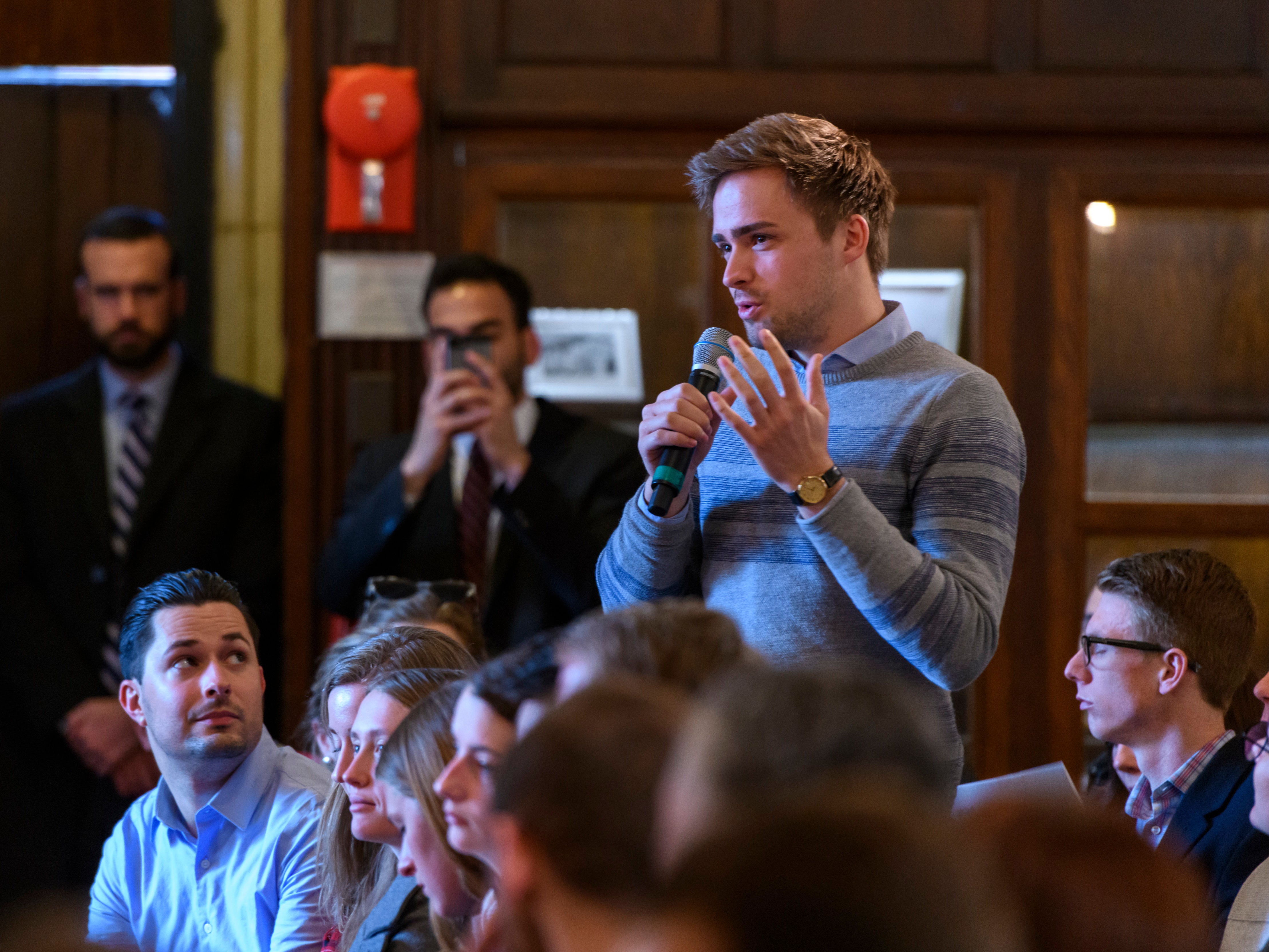 Photo of student asking a question at event