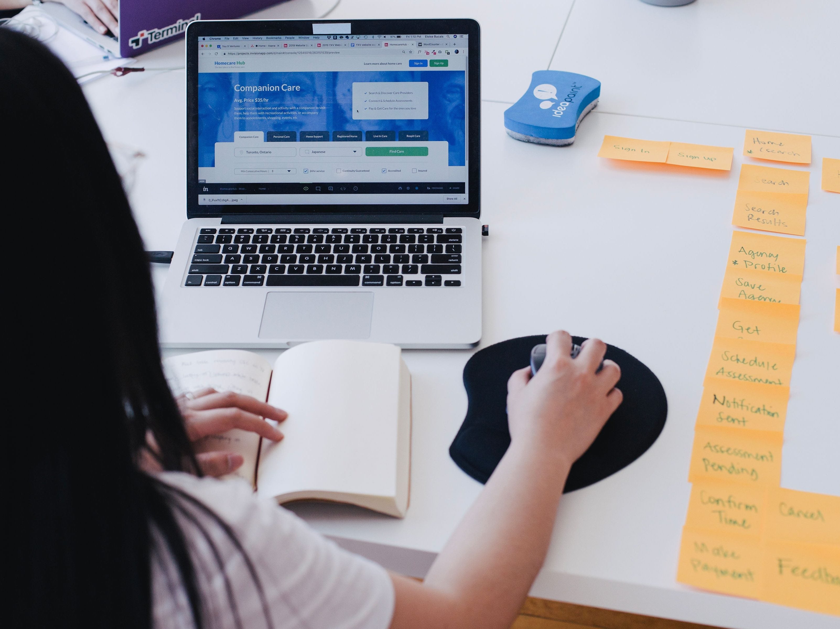 Woman on laptop with post-it notes to the right