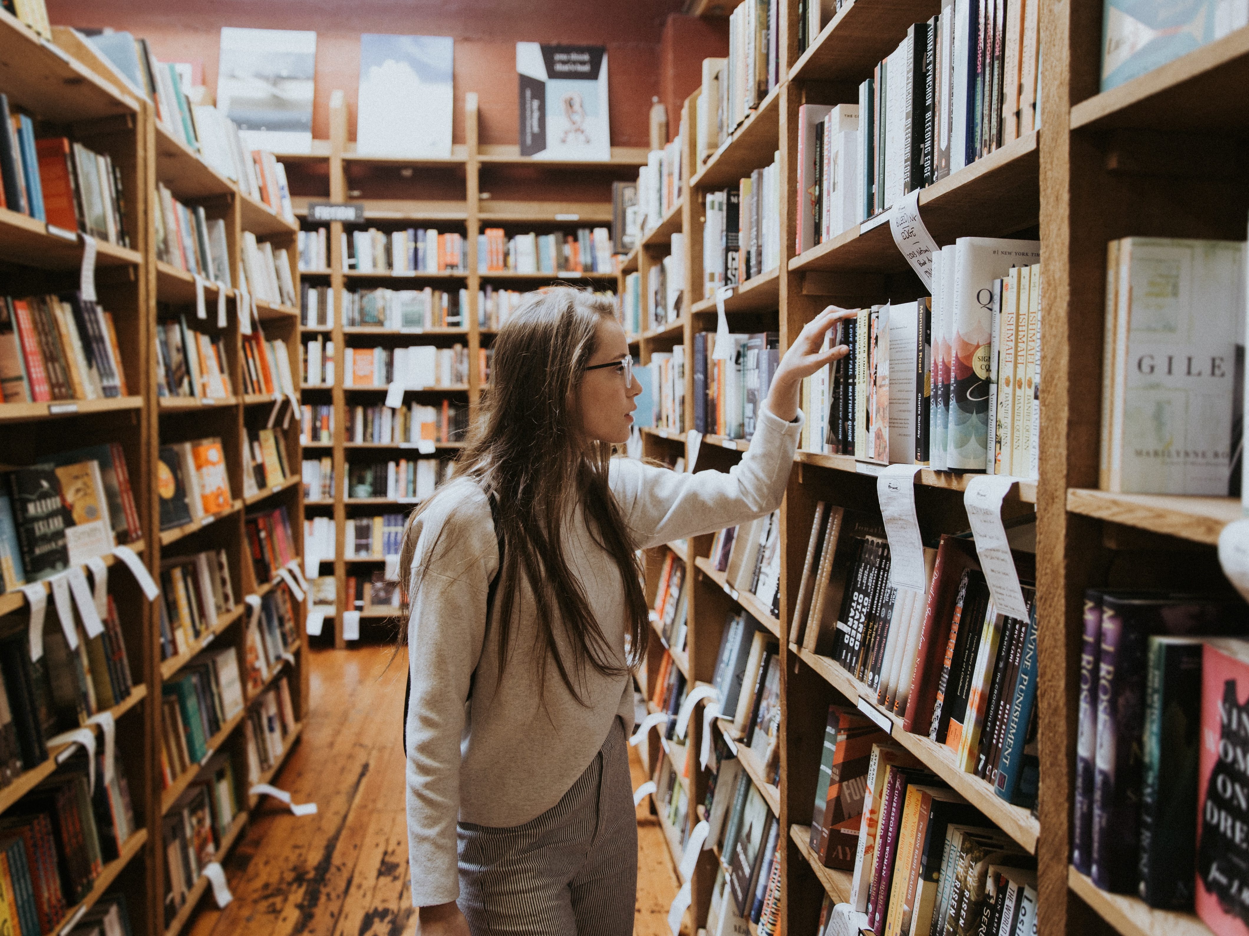 Woman looking at books in library